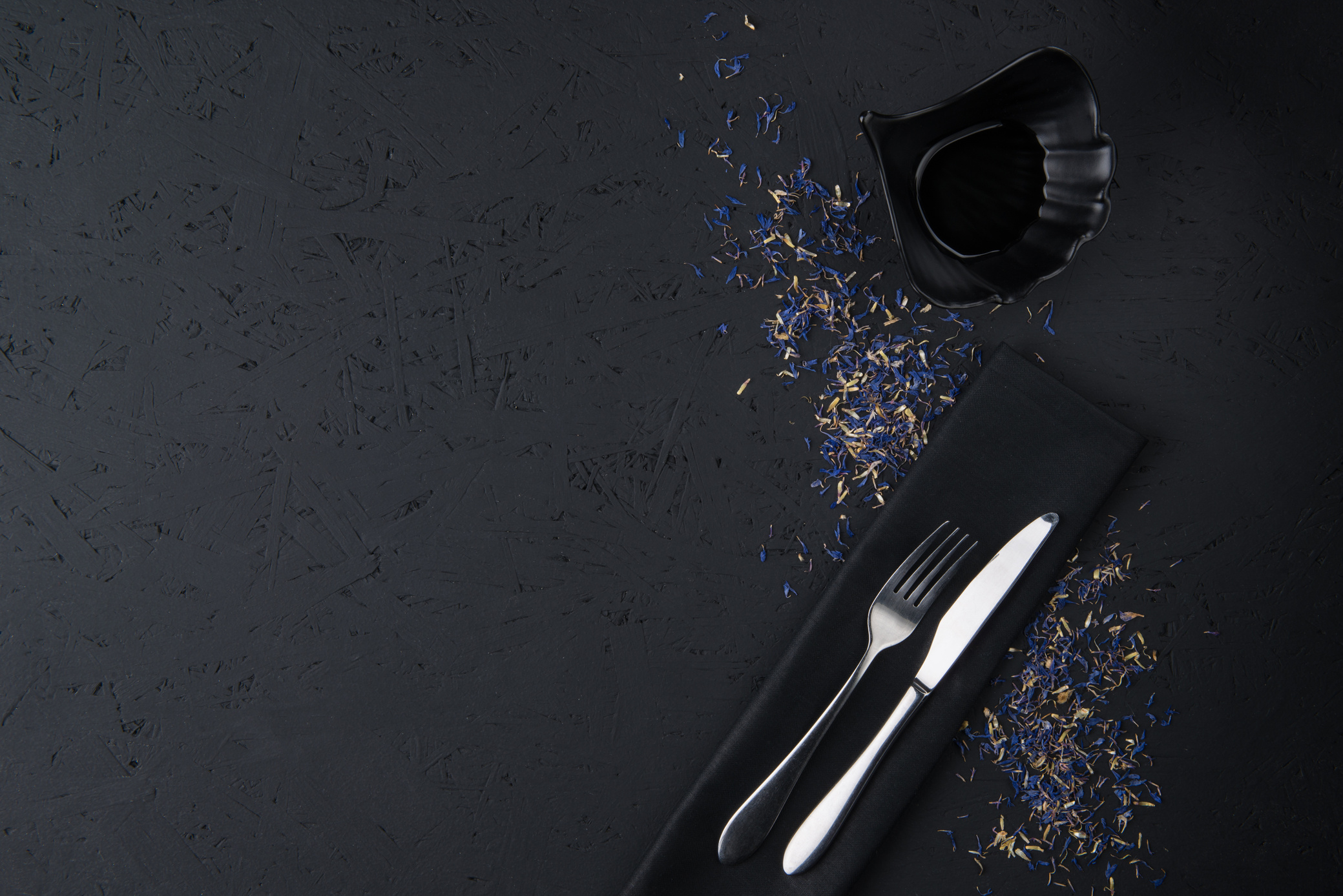 Utensils and Soy Sauce on a Black Background 